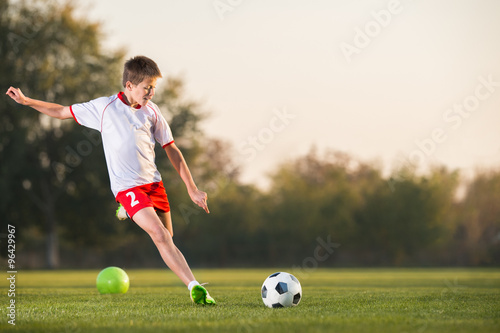 kid kicking a soccer ball © Dusan Kostic