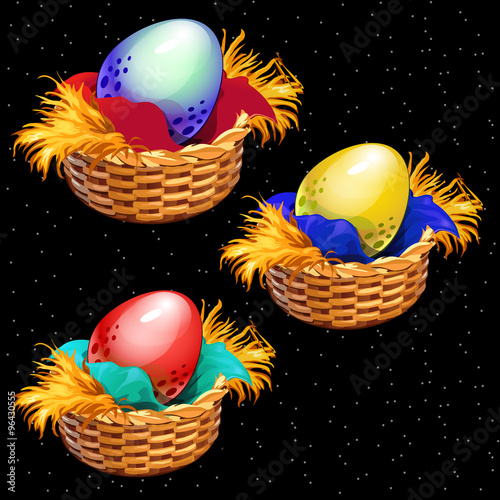 Three colored eggs closeup in straw baskets on a black background