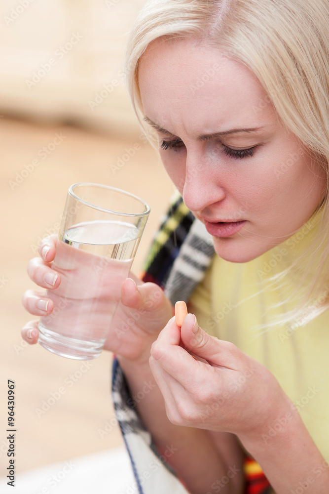 Cheerful ill girl is receiving treatment for flu Cheerful ill girl is receiving treatment for flu