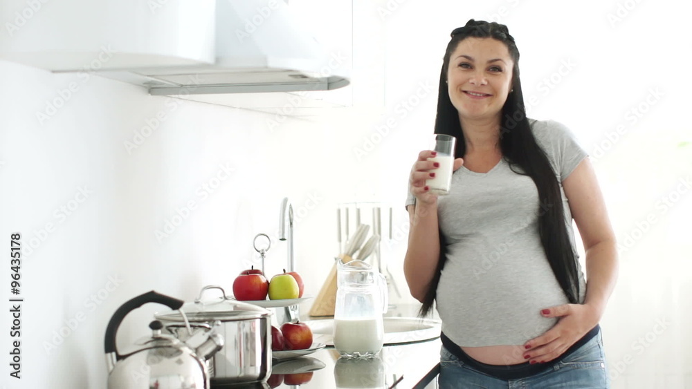 Pregnant woman drinking milk Pregnant woman drinking milk