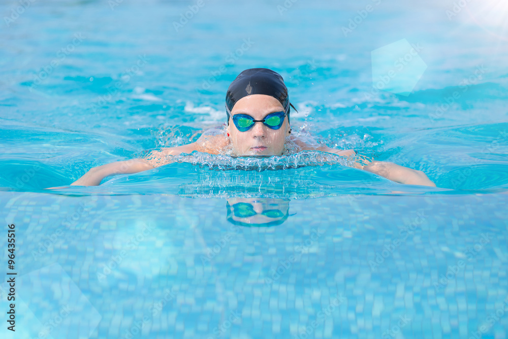 Young girl swimming butterfly stroke style