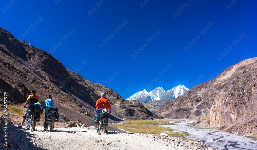 Cyclists standing on mountains road. Himalayas, Jammu and Kashmir State, North India