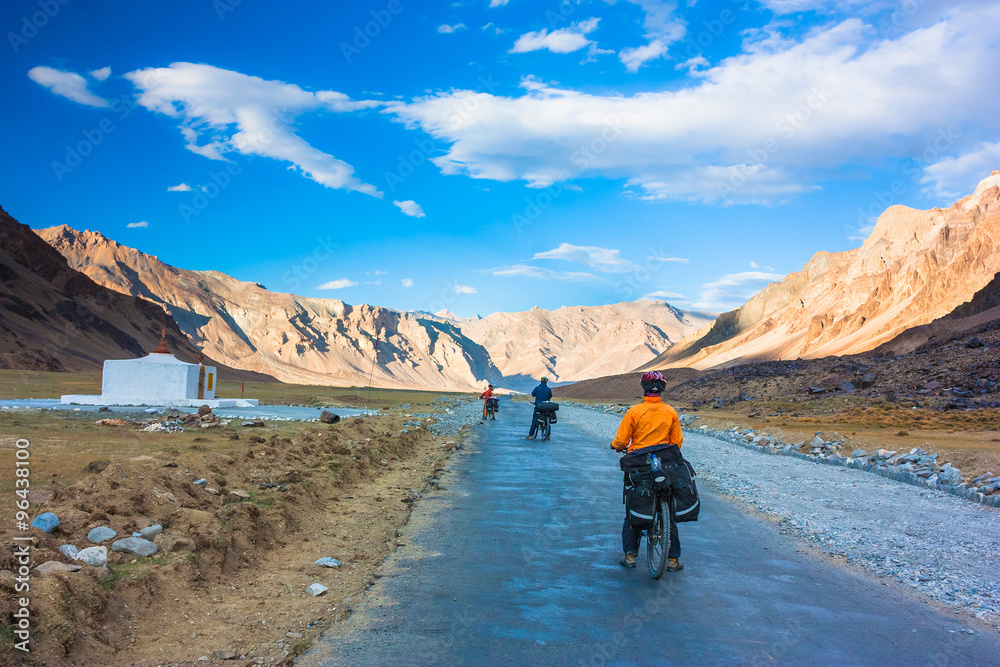 Two cyclist standing on mountains road. Himalayas, Jammu and Kashmir State, North India