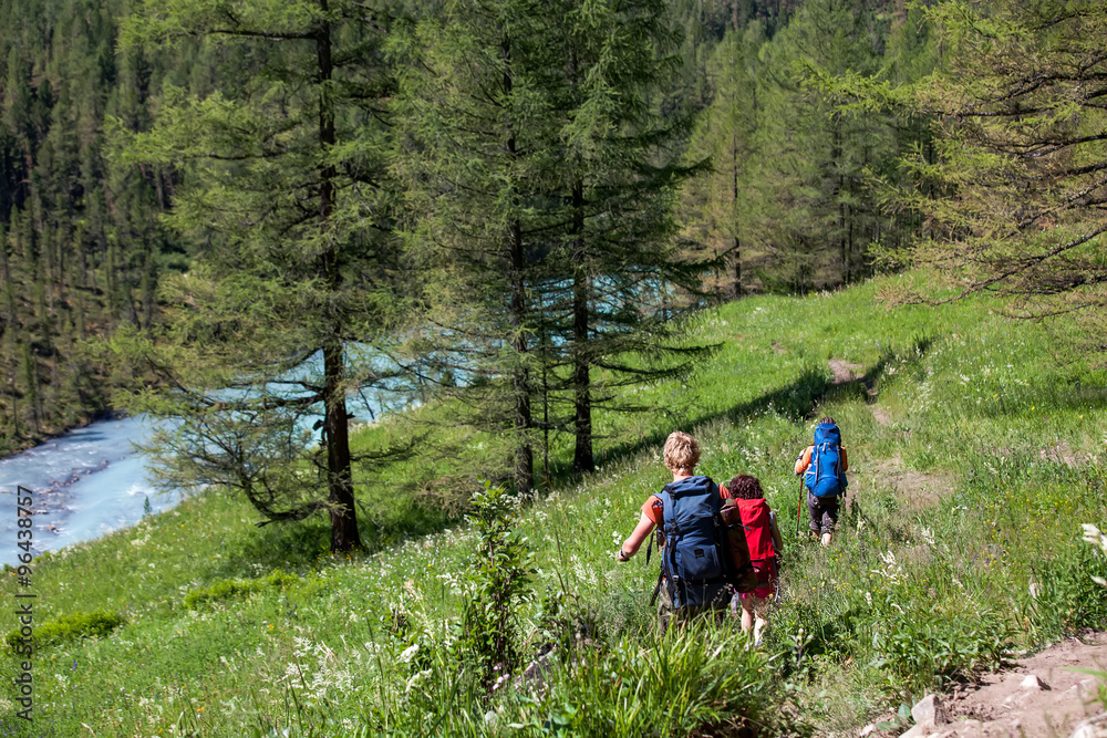 Company of young people are hiking in Altai mountains