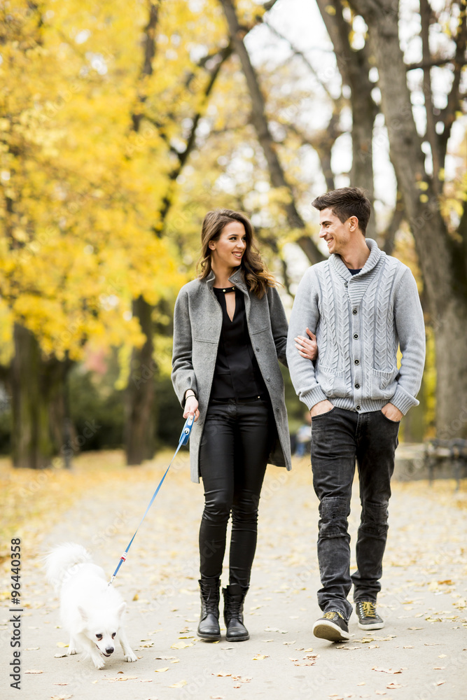 Young couple with dog in the autumn park Young couple with dog in the autumn park