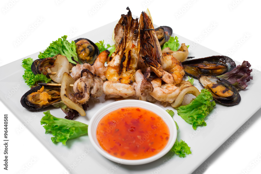 Grilled seafood platter with hot sauce. Grilled seafood platter with hot sauce.