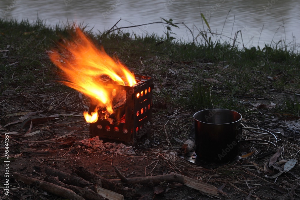 Tourist mini stove in the autumn forest Tourist mini stove in the autumn forest