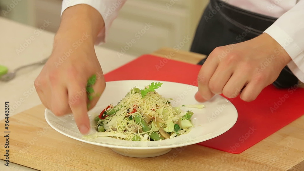 Chef is cooking hot vegetable salad Chef is cooking hot vegetable salad