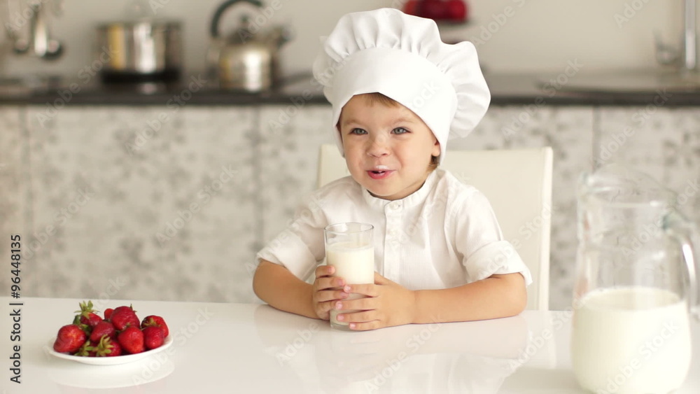 Little boy sitting and drinking milk Little boy sitting and drinking milk