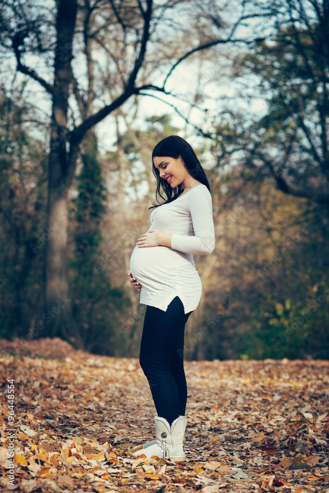 Pregnant woman posing in the park Pregnant woman posing in the park