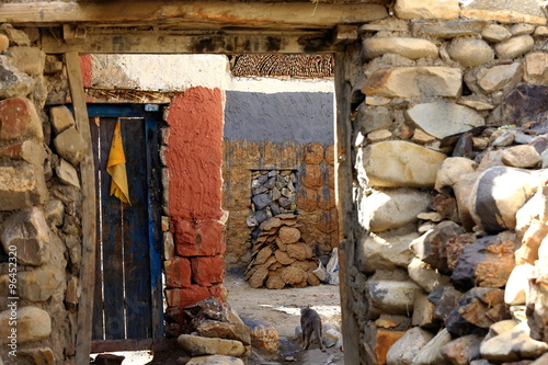 Wooden door on stone wall. Sakya-Tibet. 1827
