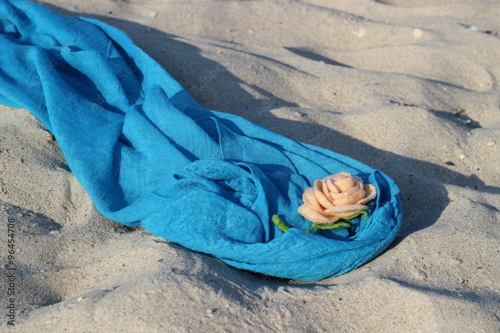 Fototapeta premium Textile handmade rose on a blue pareo