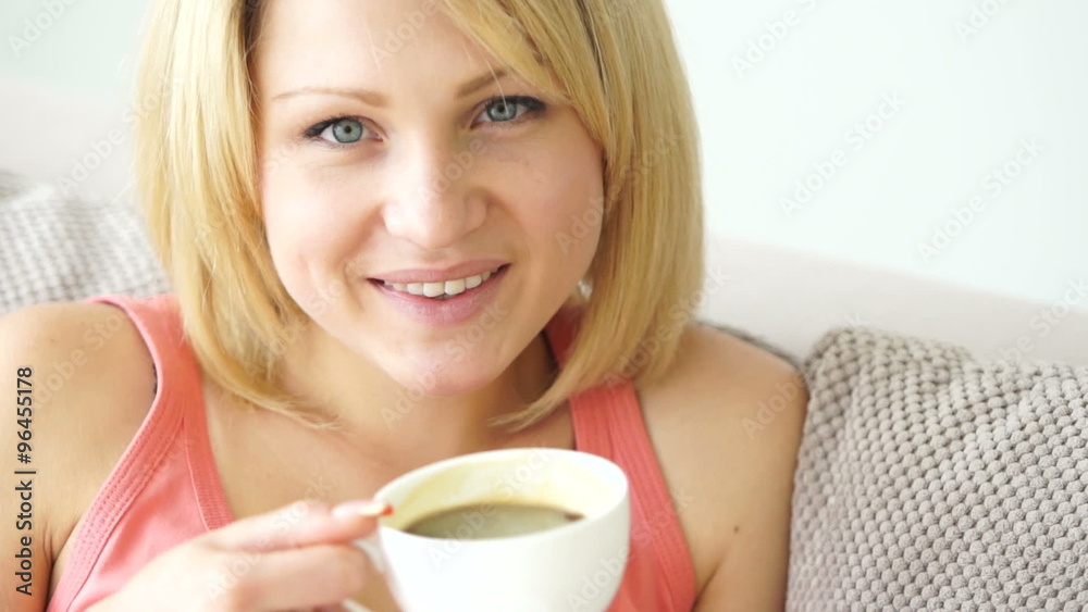 Girl drinking coffee and smiling. close-up Girl drinking coffee and smiling. close-up