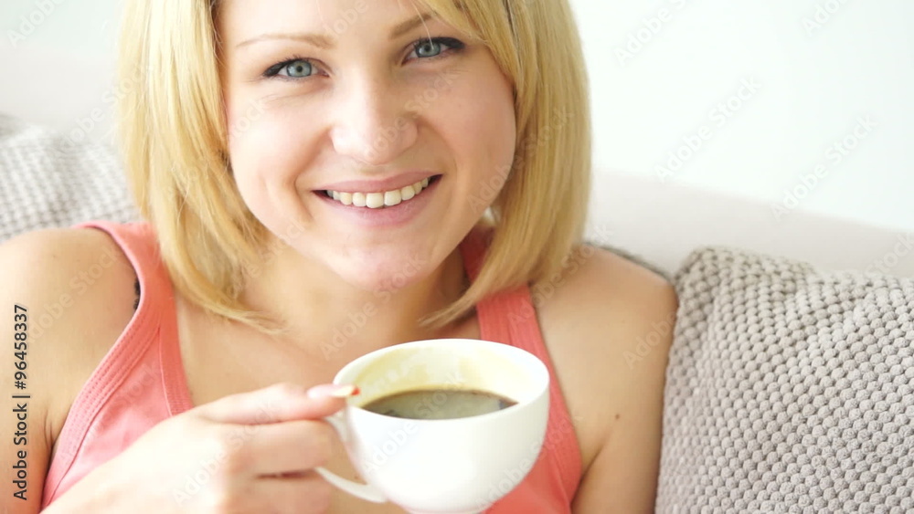 Young adult drinking delicious coffee and smiles. close-up Young adult drinking delicious coffee and smiles. close-up