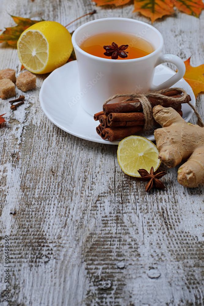 Ginger, lemon and cop of tea on light background