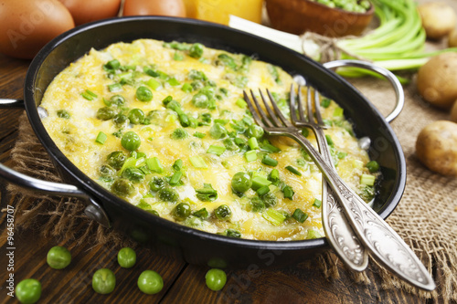 Omelette with green peas, potatoes and cheese