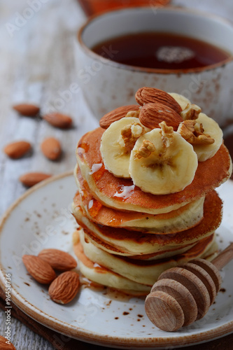 Pancakes with nuts, banana and maple syrup