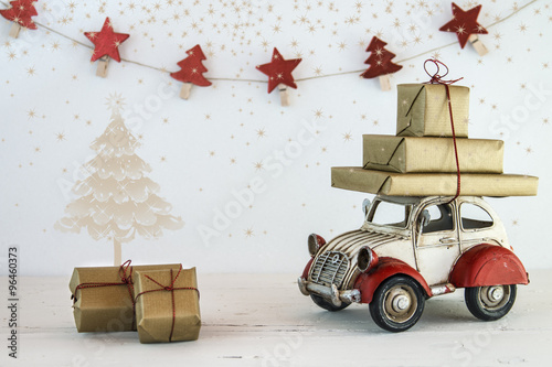 Christmas holiday concept with gift boxes on toy car
