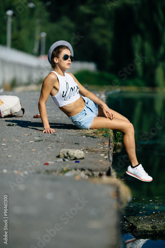 beautiful girl sitting on the pier