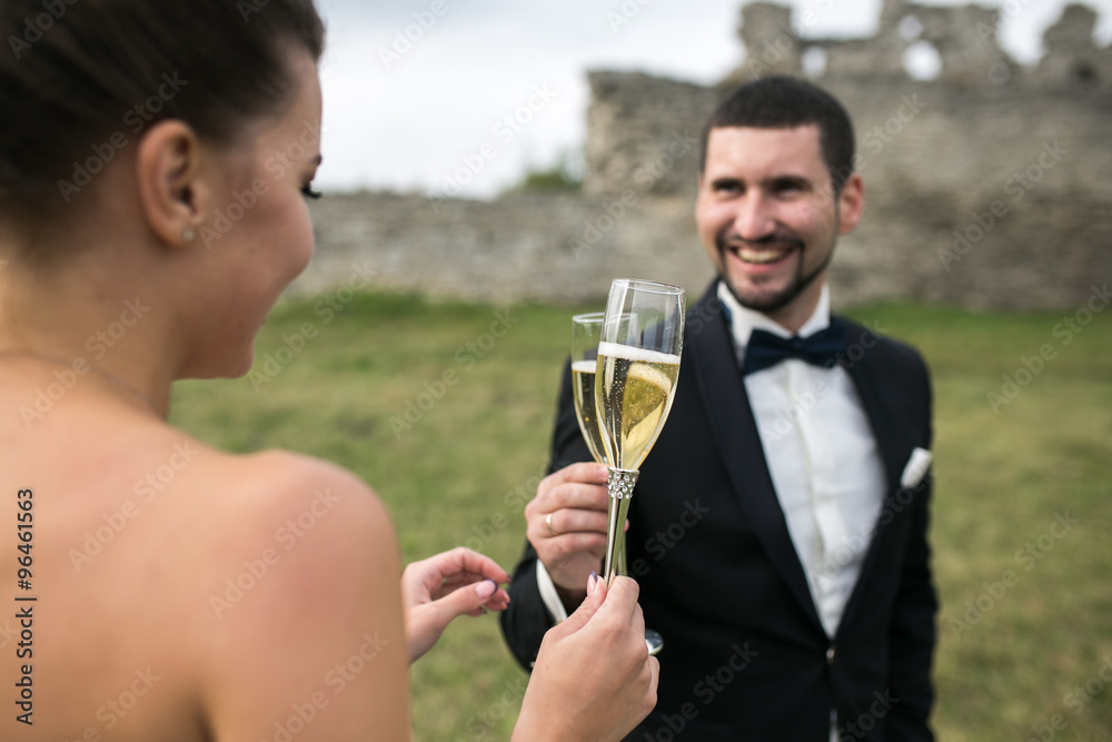 bridal couple clink glasses of champagne bridal couple clink glasses of champagne