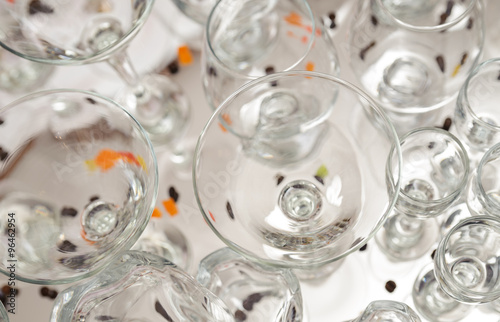 Glasses of different sizes are on the white tablecloth.