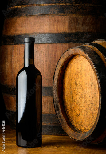 red wine bottle on wooden background