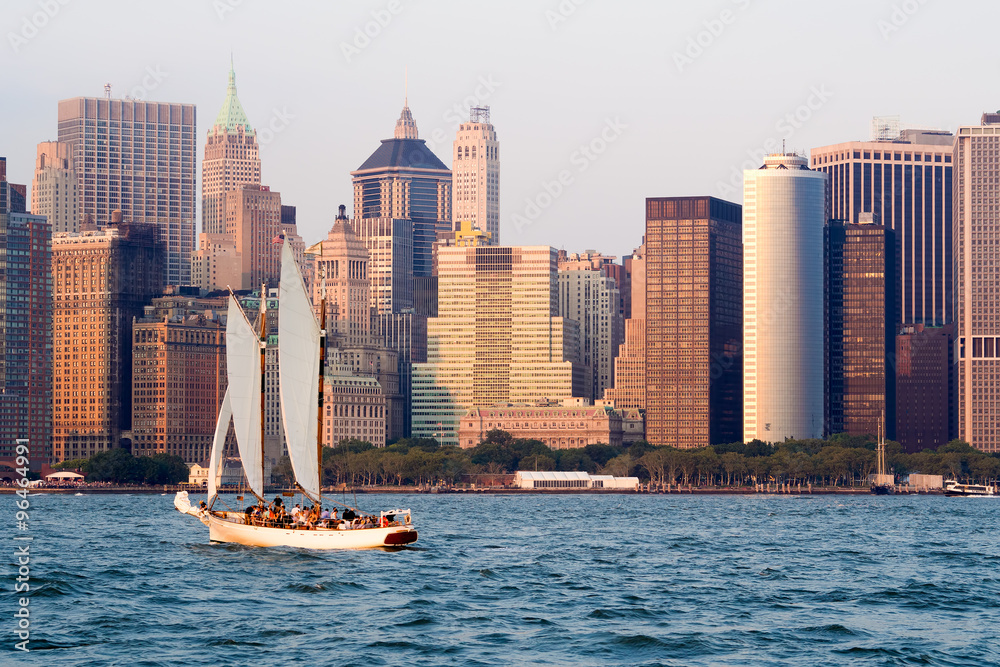 Fototapeta premium The lower Manhattan skyline in New York with a sailboat