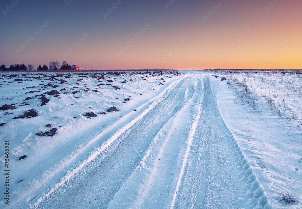traces of the car wheels on a snowy road