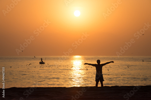 Gymnastic on the sunrise beach in Sarjah UAE photo