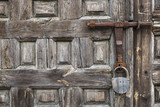 old wooden door with a rusty bolt and a padlock