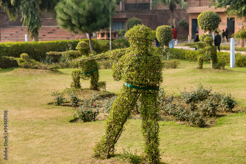 Topiary hedge figures depicting British soldiers firing rifles at the site of the Jallianwala Bagh massacre in Amritsar, India. photo