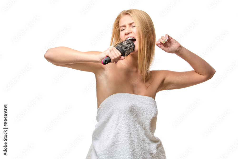 Happy pretty woman in towel singing using comb having fun Happy pretty woman in towel singing using comb having fun