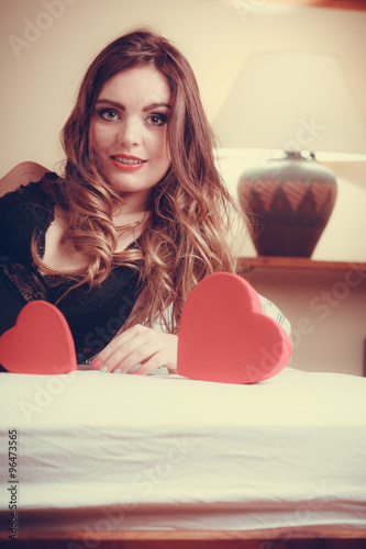 Woman in lingerie in bed. Valentines day love.