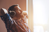 handsome bearded man in headphones listening to music