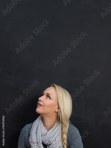 smiling student or teacher at the blackboard
