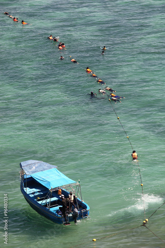 Student scuba divers in the water during a rescue dive course,Thailand. photo