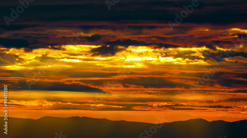 4K Greek golden sunset landscape timelapse silhoueted mountains light rays beams photo