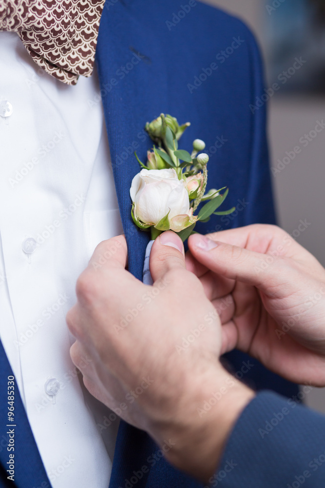 Boutonniere on trendy groom at wedding Boutonniere on trendy groom at wedding