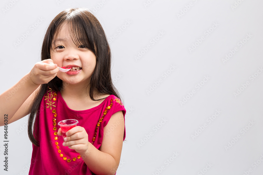 Fototapeta premium Kid Eating Gelatin Dessert / Kid Eating Gelatin Dessert Background