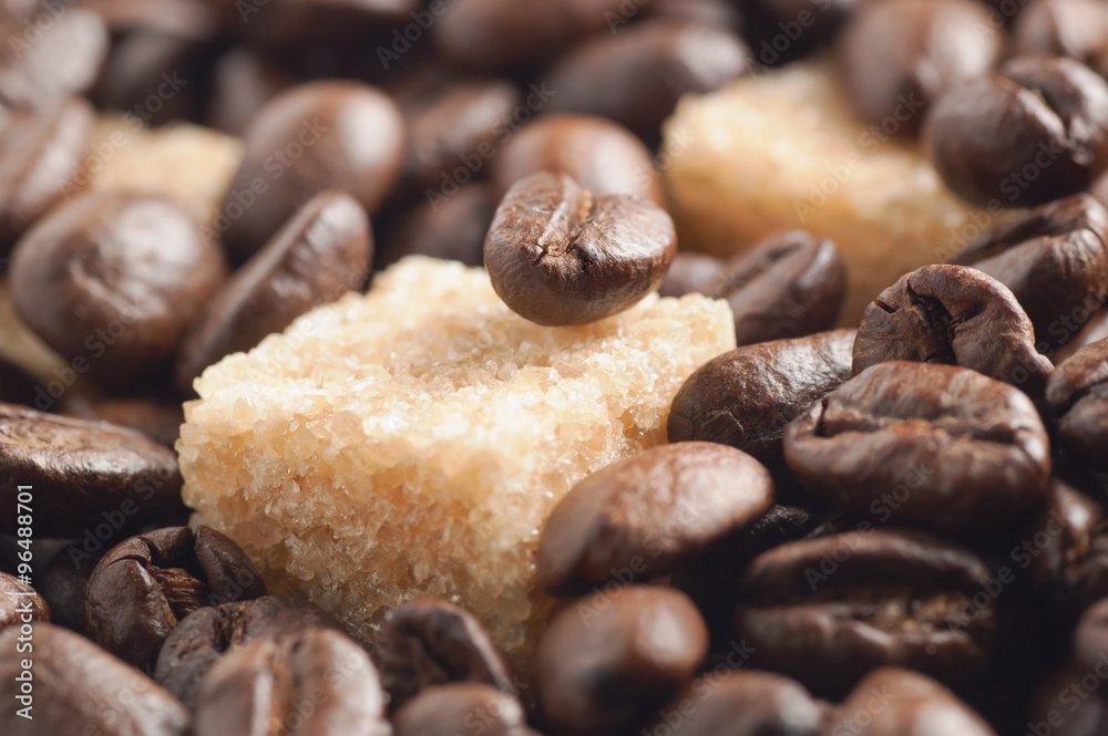 Cane sugar cubes covered by roasted coffee beans Cane sugar cubes covered by roasted coffee beans