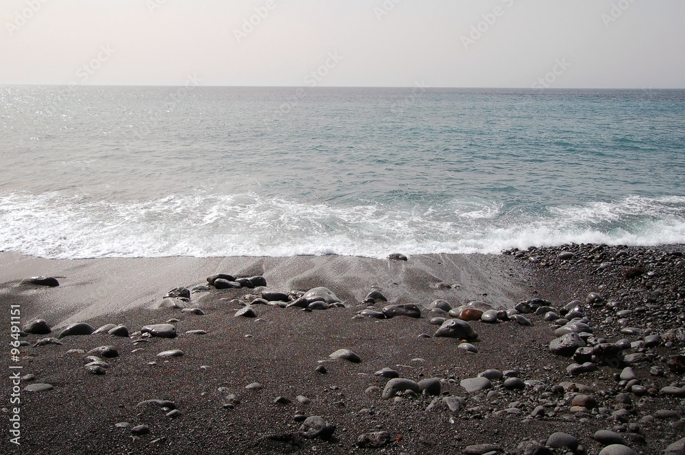 Black sand beach with volcanic stones Black sand beach with volcanic stones