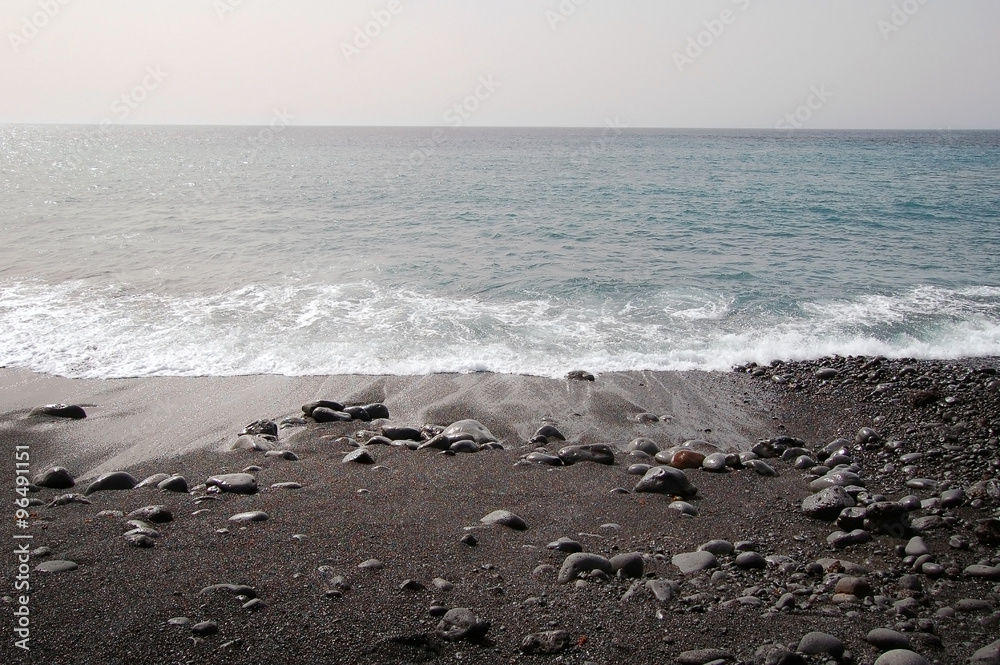 Black sand beach with volcanic stones