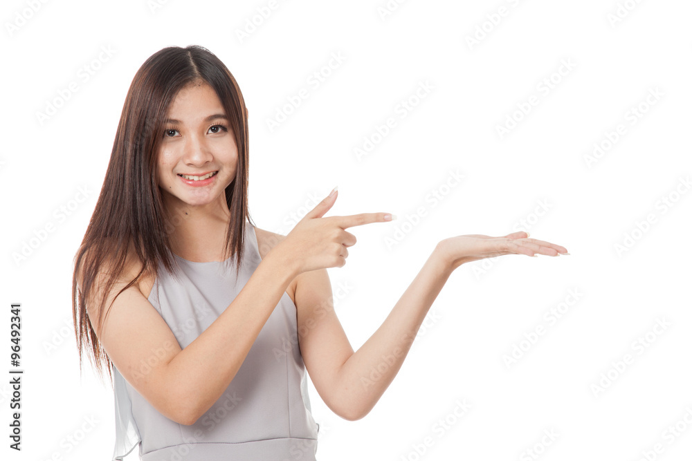 Beautiful young Asian woman point to palm hand Beautiful young Asian woman point to palm hand