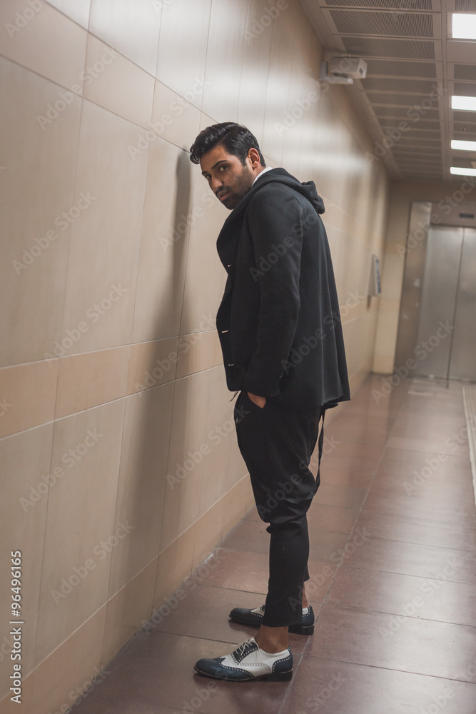 Fototapeta premium Handsome Indian man posing in a metro station