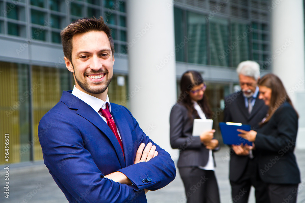 Beautiful man on the background of business people Beautiful man on the background of business people