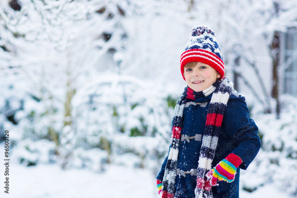 Happy child having fun with snow in winter Happy child having fun with snow in winter