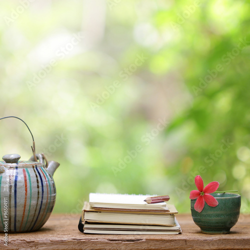 Old vintage teapot and notebooks at outdoor