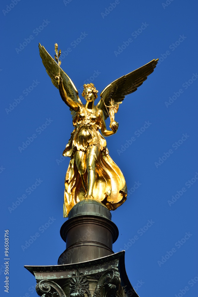 Fototapeta premium MUNICH, GERMANY - Gilded statue featuring a Peace Angel (Friedensengel) on the top of a column