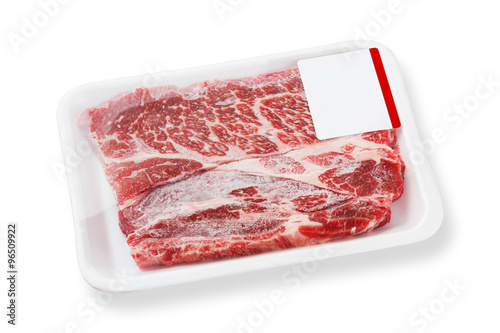 Frozen beef chuck steak on foam tray