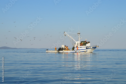Fishing Boat Followed By Seagulls